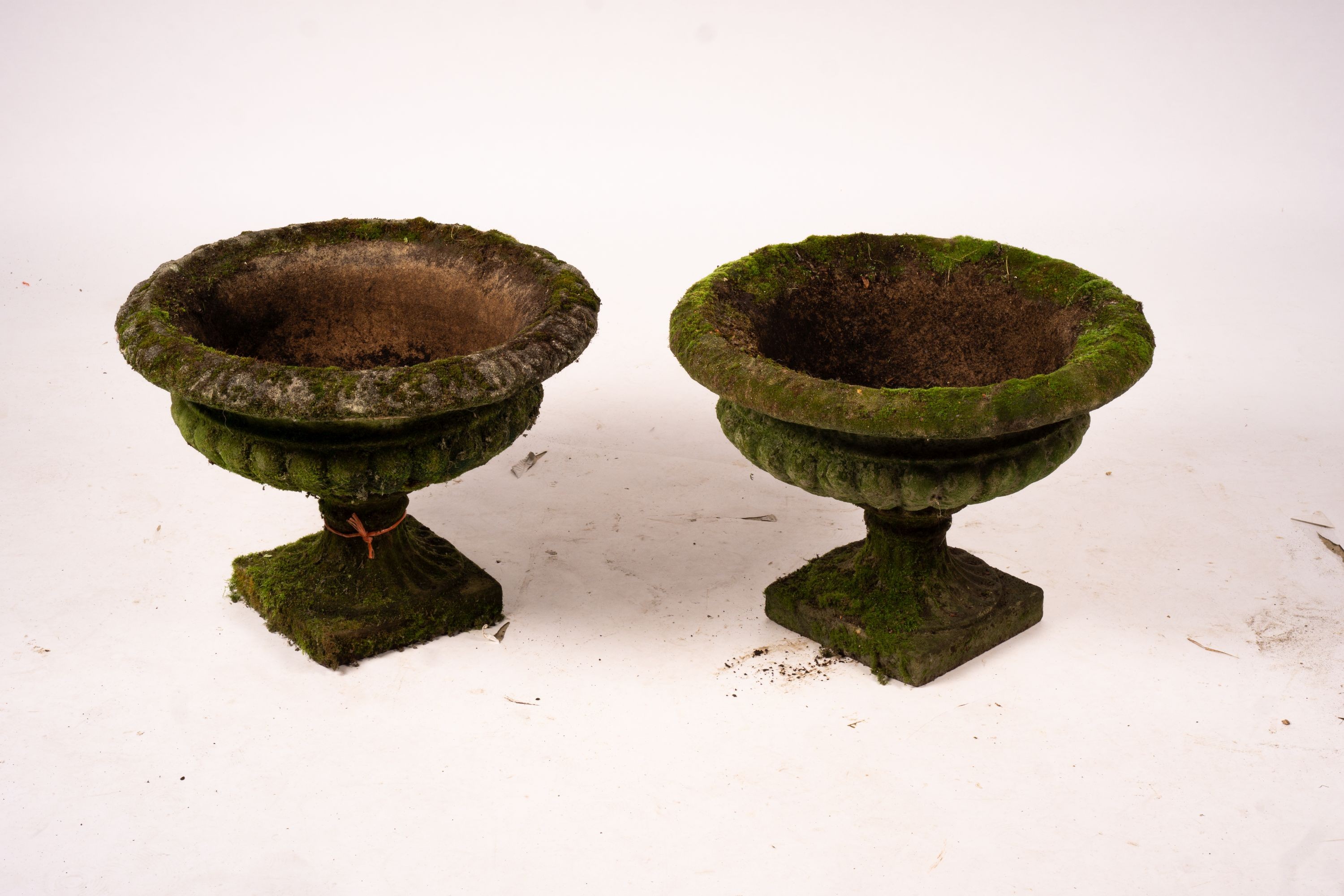 A pair of weathered reconstituted stone campana garden urns, Diam.56cm H.42cm